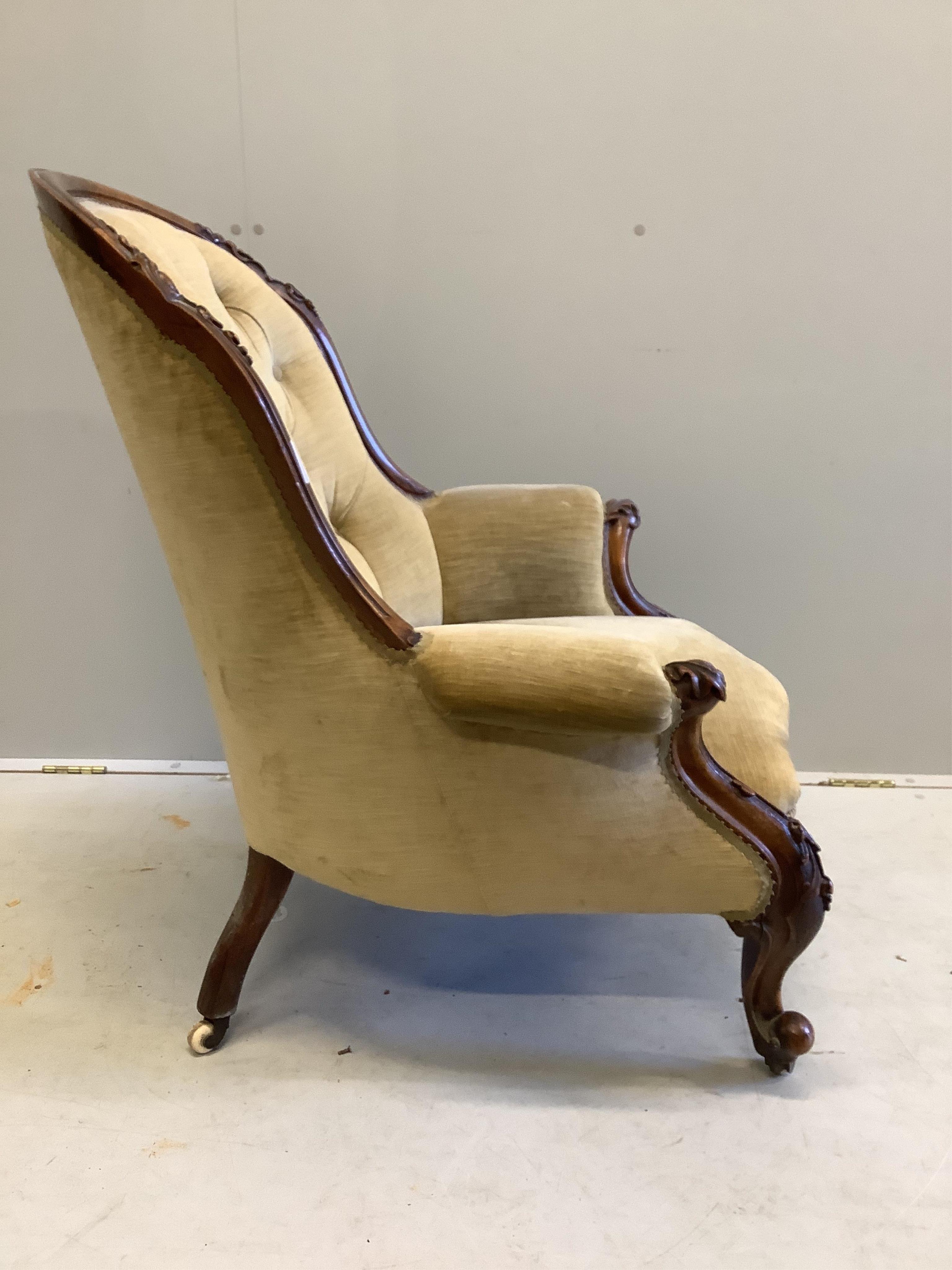 A Victorian walnut upholstered spoonback armchair, width 75cm, depth 80cm, height 94cm. Condition - fair